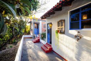 a house with a blue door and red stairs at Casa Aurora Garden Retreat in Ajijic