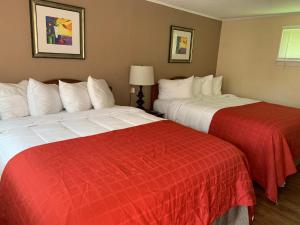 two beds sitting next to each other in a hotel room at Beachway Motel in Salisbury