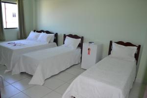 Katil atau katil-katil dalam bilik di Palace Hotel Pôr do Sol