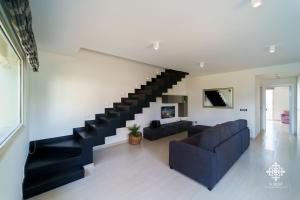 uma sala de estar com um sofá e uma escada em Villa Vittoria - Waterfront house em Augusta