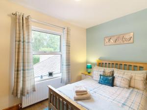a bedroom with a bed and a window at Three bedroomed house with a separate studio apartment by Severn Valley railway in Highley