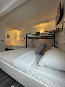 a bedroom with a large white bed in a room at Hotel and the City, Rooftop City View in New York