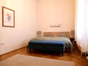 a bedroom with a bed in the corner of a room at Contemporary City Apartment Váci Utca in Budapest