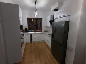 a kitchen with a black refrigerator and a desk at Villa MISTRAL przy plaży in Sława +15 photos