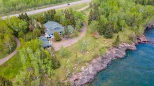 an aerial view of a house next to a river at Thomsonite Inn on Lake Superior in Grand Marais