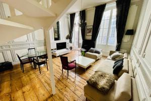 a living room with a couch and a table at T4 apartment in the heart of old Bordeaux close to all amenities in Bordeaux