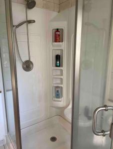 a shower with a glass door in a bathroom at Guest Room in Eatontown