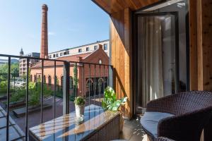 a balcony with a table and a view of a building at City Lights Apartments in Krakow