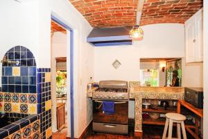 a kitchen with a stove and a counter top at Casa Aurora in Ajijic