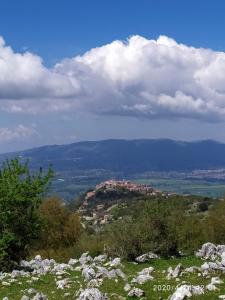 un pequeño pueblo en la cima de una colina con nubes en Il Borgo Antico, en Rocca Massima