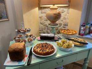 a table topped with lots of different types of cakes and pastries at Il Borgo Antico in Rocca Massima
