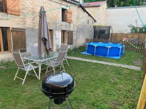 - un barbecue et un barbecue dans la cour dans l'établissement Petite maison lorraine avec cheminée et jardin, à Saint-Mihiel