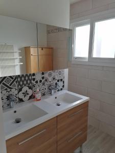 a bathroom with a white sink and a mirror at Le Petit Cabanon in Sapois +17 photos