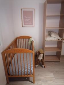 a baby room with a crib and a bunk bed at Le Petit Cabanon in Sapois