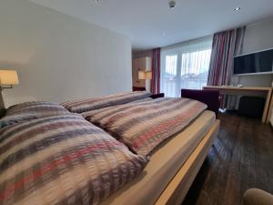 Postel nebo postele na pokoji v ubytování Hotel Astoria