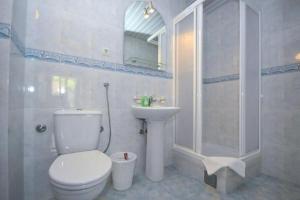 a bathroom with a toilet and a sink and a shower at Vila Tamara Apartmani in Bečići +38 photos