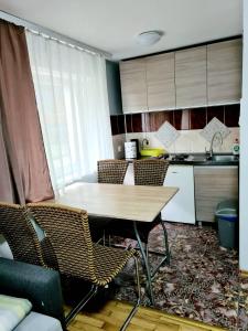 a kitchen with a table and chairs in a room at Willa Wiosenna in Kołobrzeg