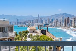 a view of a city and the ocean with buildings at La Perla Benidorm Apartment seaview & pool Levante Beach in Benidorm