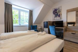 Postel nebo postele na pokoji v ubytování Landhotel Gutshof im Oertzetal in Oldendorf, Südheide