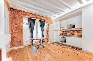 a kitchen with a table and a brick wall at Luxury Apartment in Milan Center in Milan