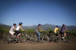 a group of people riding bikes on a dirt road at Mapuyampay Lodge Gastronómico in Santa Cruz