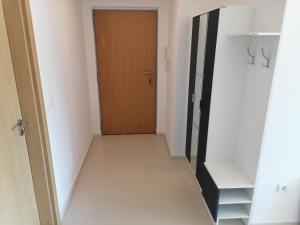 um corredor com uma porta de madeira e um quarto em Apartman Sara em Pržno