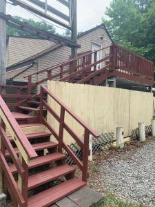 a set of stairs leading up to a house at 3-Bedroom apt. ideal location near new river gorge in Fayetteville