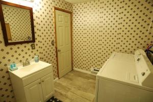 a bathroom with a white sink and a mirror at 3-Bedroom apt. ideal location near new river gorge in Fayetteville +11 photos