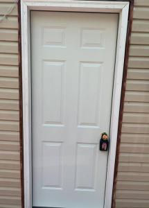 a white door on a house with a tag on it at 3-Bedroom apt. ideal location near new river gorge in Fayetteville
