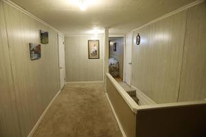a hallway of a home with wood paneled walls at 3-Bedroom apt. ideal location near new river gorge in Fayetteville
