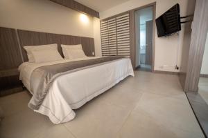 Postel nebo postele na pokoji v ubytování Hotel Torre Poblado