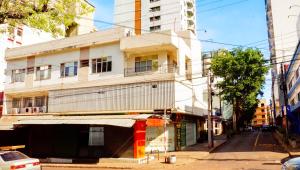 um edifício de apartamentos numa rua numa cidade em Turis Hotel em Ciudad del Este