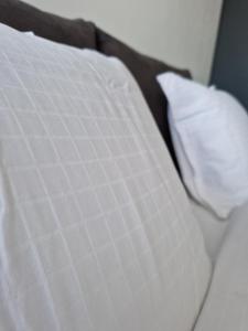 a close up of a white pillow on a bed at Apartment Enya in Burgas