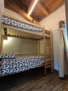 a bedroom with two bunk beds and a ladder at Appartamenti il bersaio Alloggio 3 in Sambuco