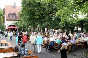 a crowd of people sitting at tables in a park at Brauerei Gasthof Kraus in Hirschaid +14 photos