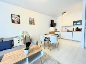 a living room with a couch and a table at Apartament Nadmorski - Plac Unii - Parking in Gdynia