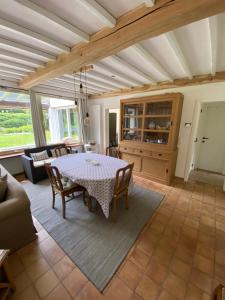 a dining room with a table and chairs at Maison L’ Ambléve in Aywaille