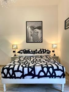 a bedroom with a black and white bed and two lamps at Leonardo & Davide Apartment Florence in Florence