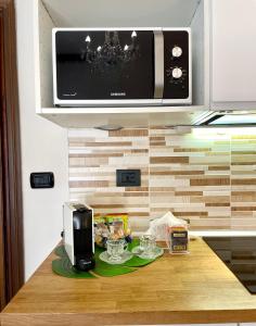 a kitchen counter with a microwave above aounter sidx sidx sidx at Leonardo & Davide Apartment Florence in Florence
