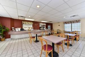 a restaurant with tables and chairs and a counter at America's Best Value Inn & Suites, Atlanta - Morrow in Morrow