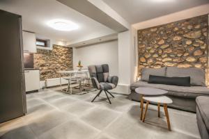 a living room with a couch and a table at Avli Luxurious House in Kalabaka