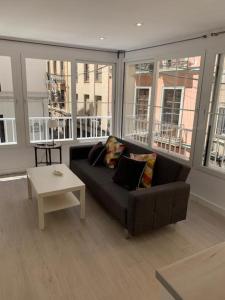 a living room with a couch and a table at Apartamento MARIANA in Granada