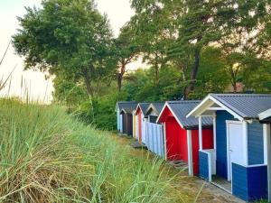 a row of colourful beach huts on a beach at Beach House Ystad in Ystad