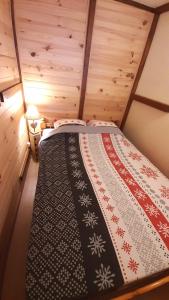 una camera da letto con letto in una camera in legno di Au Doubs Refuge a Métabief