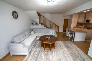 a living room with a couch and a table at Apartmani Adi&Ena in Konjic