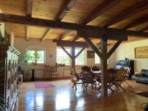a living room with a table and chairs in it at Pod Lipami in Zawady