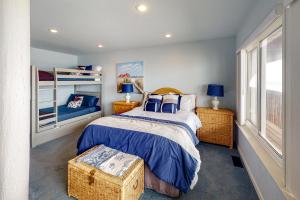 a bedroom with a bed with a blue comforter at Oceanview Paradise in Watsonville