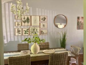 a dining room with a table with a vase on it at Three Bedroom Villa Near Cleveland Clinic, Case Western, University Hospitals in South Euclid