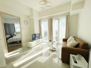 a living room with a couch and a large mirror at Inspiria in Davao City