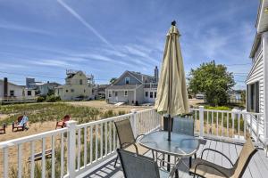 a patio with a table and an umbrella at Plum Island Retreat about 1-Block Walk to Beach! in Newburyport